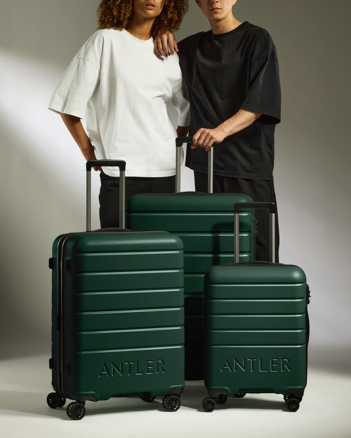 two men standing next to a group of luggage