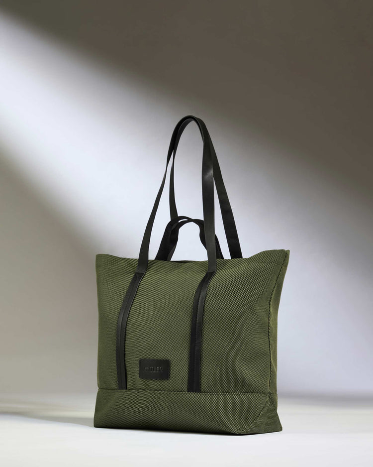 a green bag with black straps