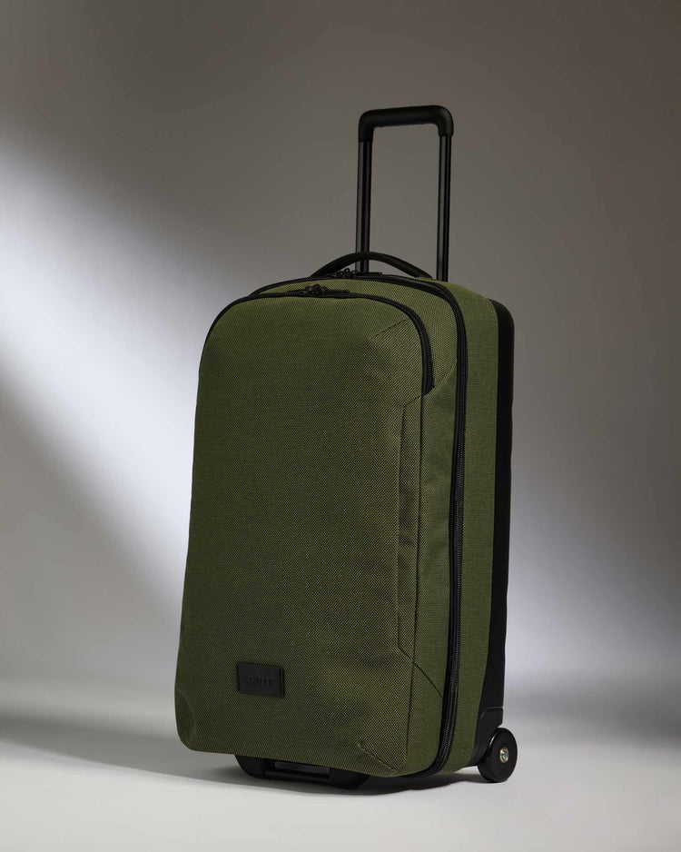 a green suitcase with wheels