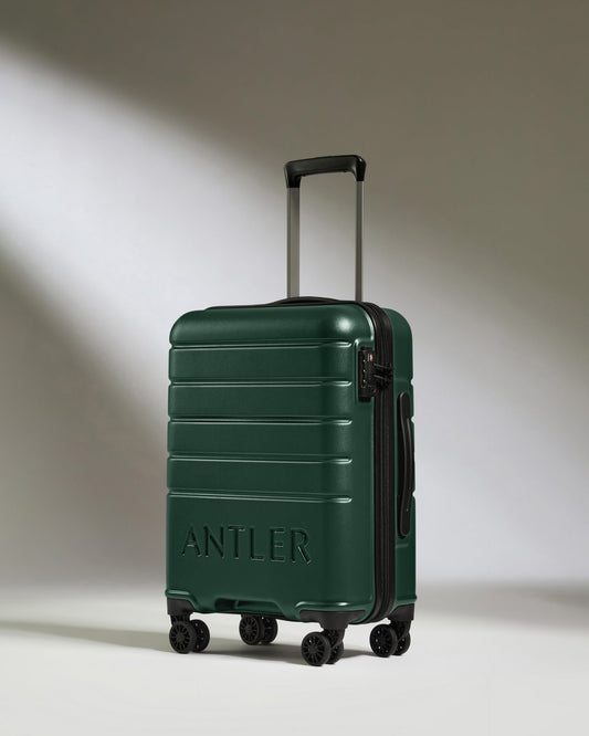 a green suitcase with wheels