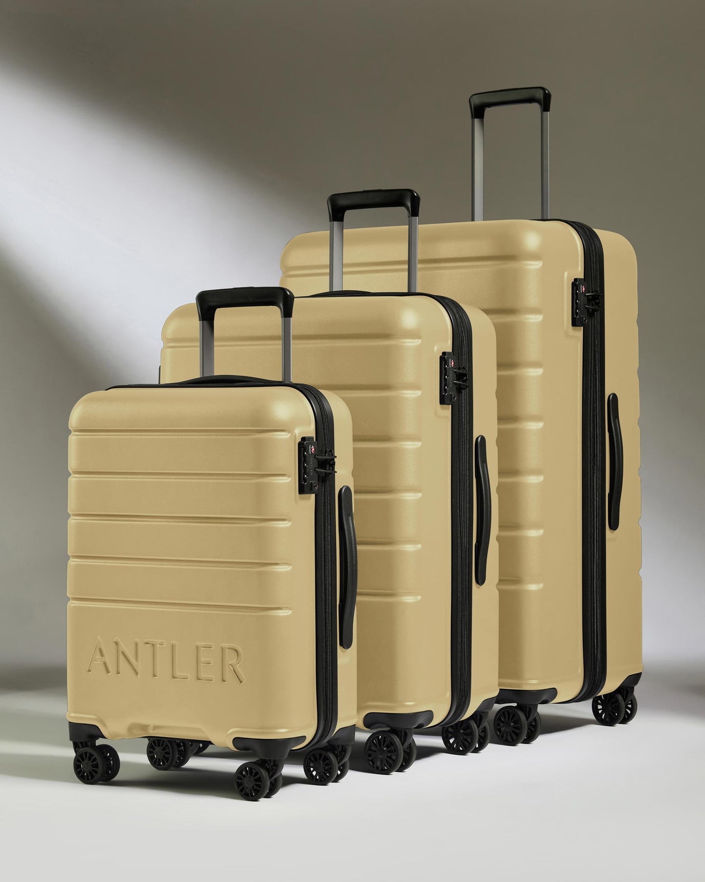 Suitcase Set in Dark Sand - Logo