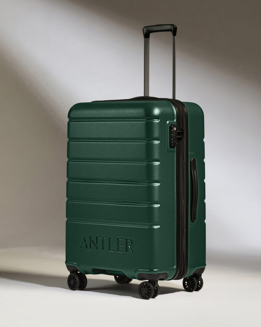 a green suitcase with two handles