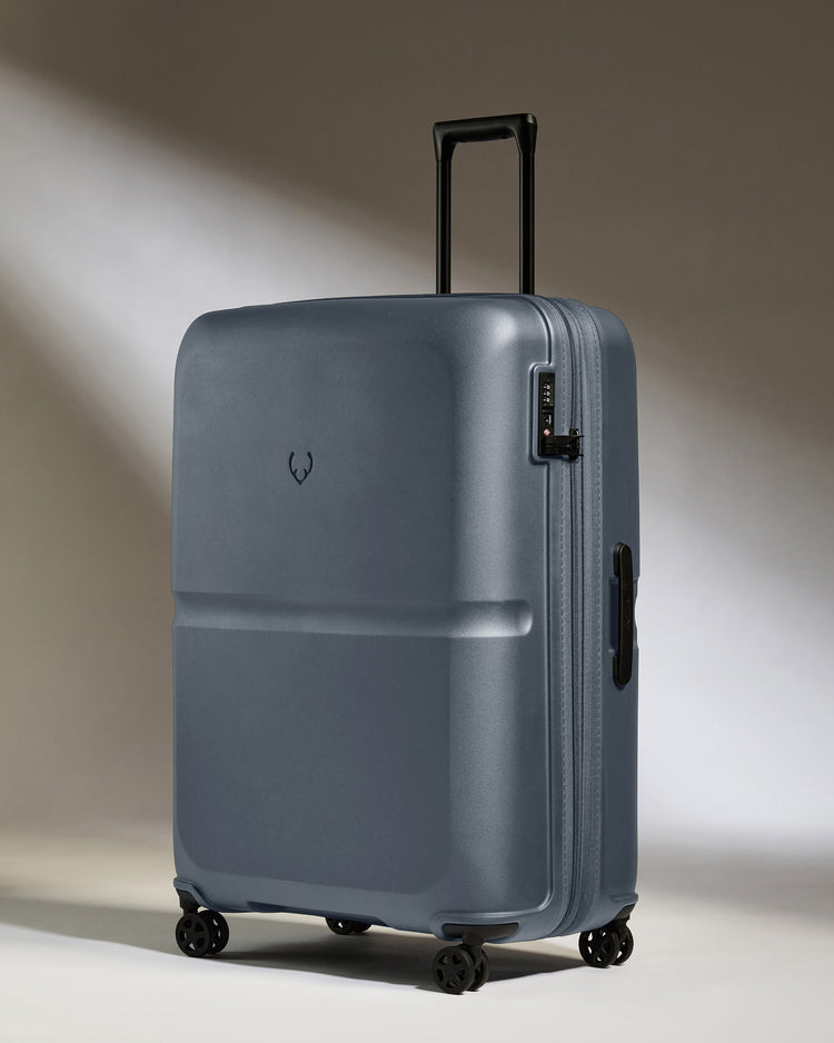 a grey suitcase with wheels
