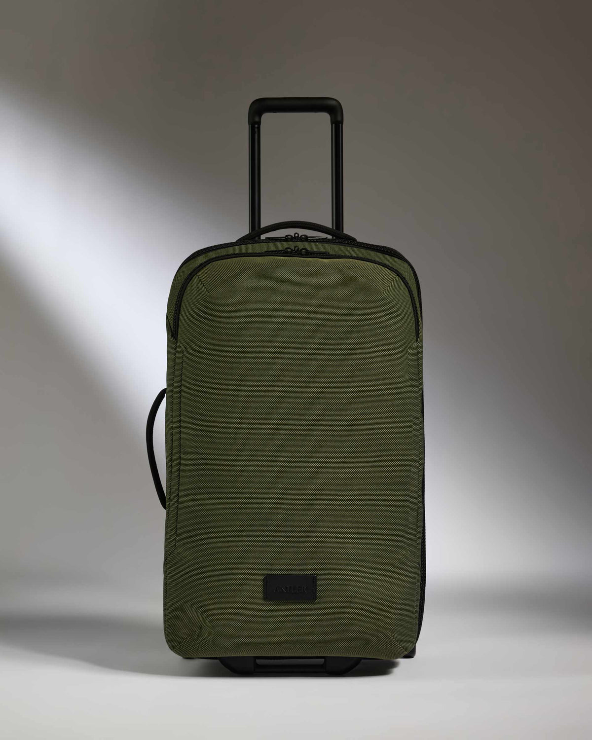 a green suitcase with handle