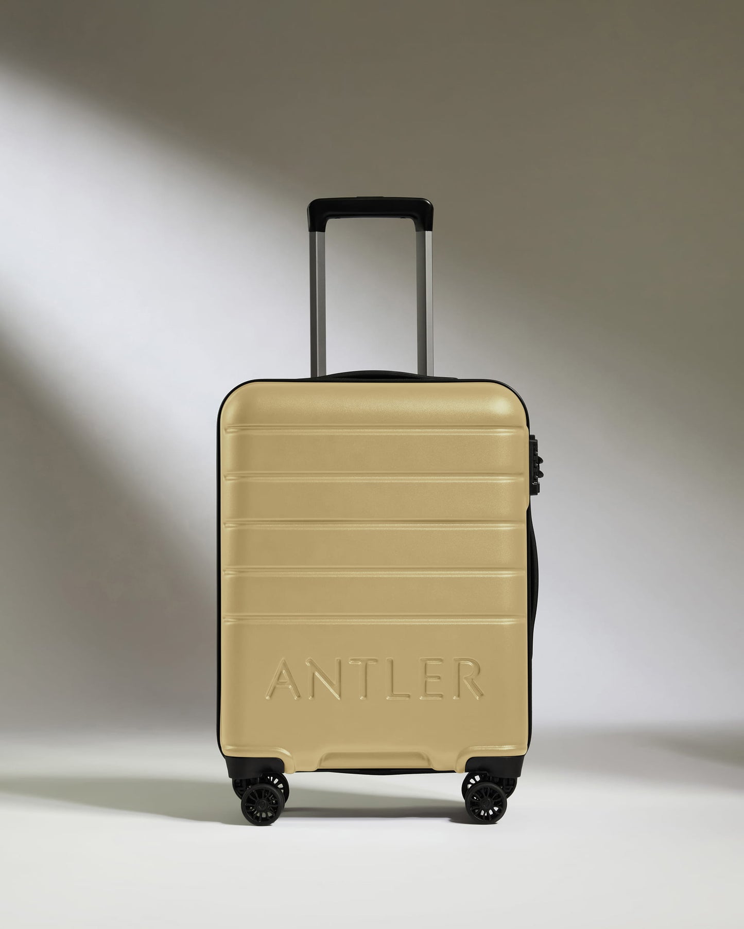 Cabin Suitcase in Dark Sand - Logo