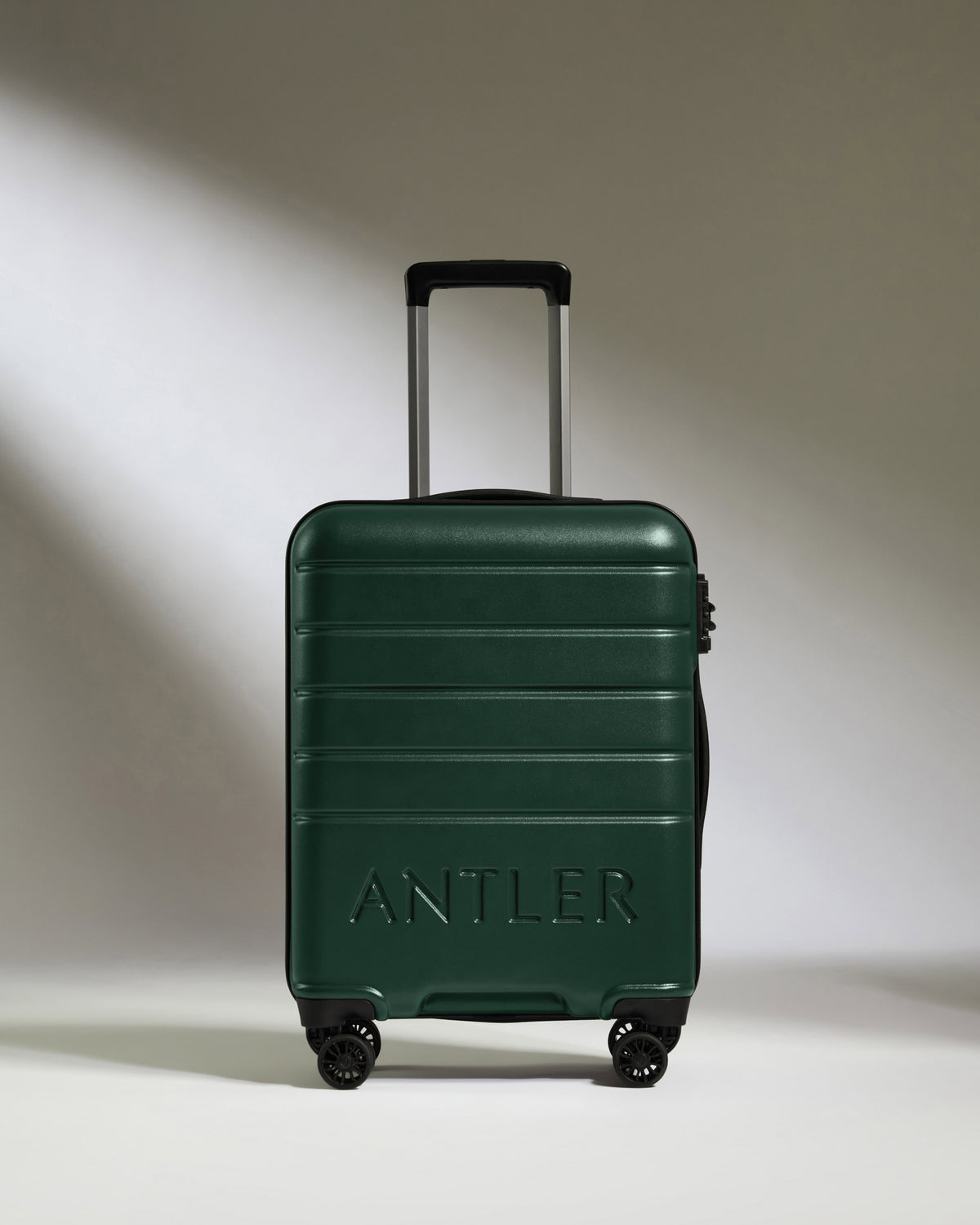a green suitcase with wheels