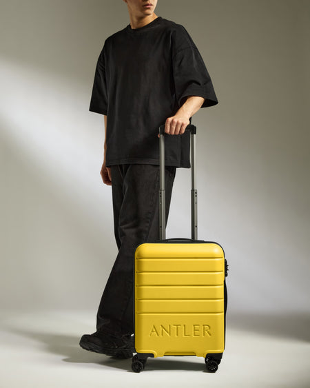 Cabin Suitcase in Mustard Yellow - Logo