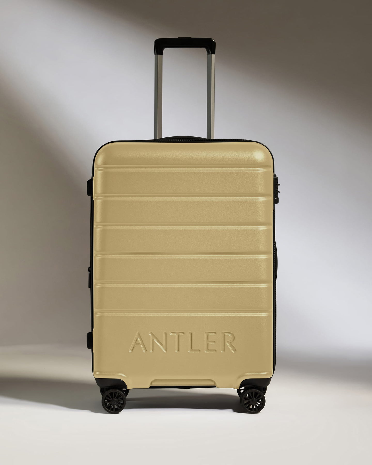 Medium Suitcase in Dark Sand - Logo