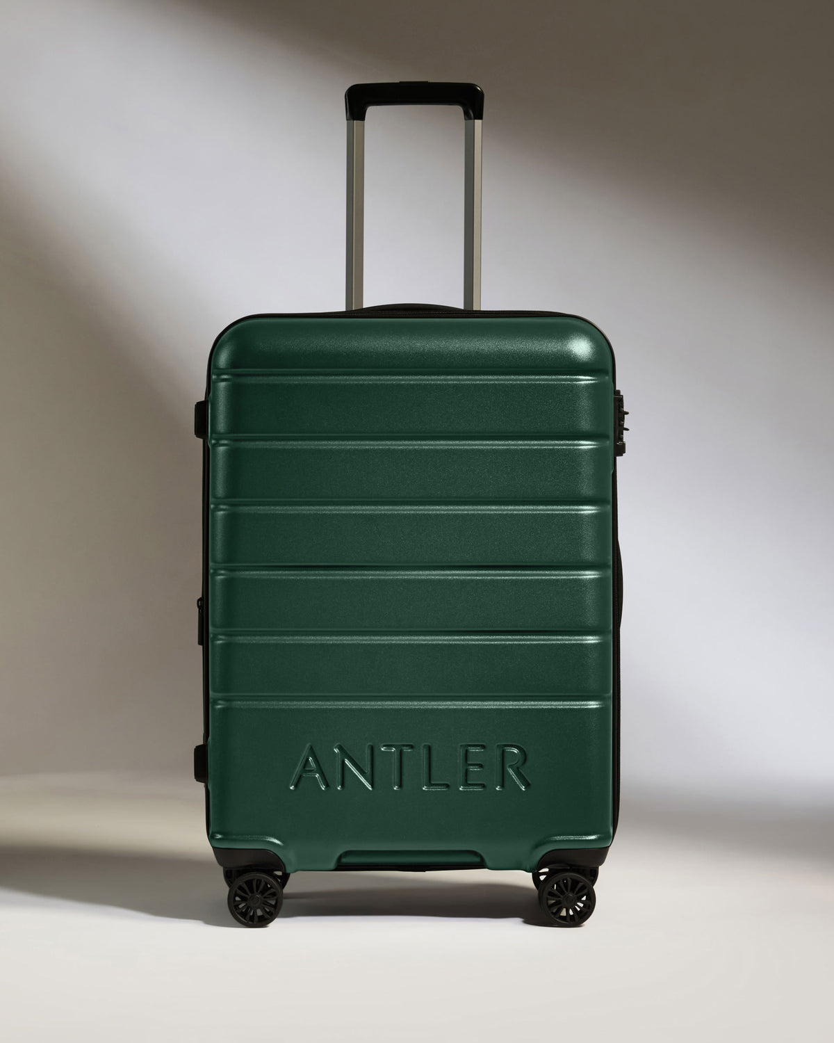 a green suitcase with handle