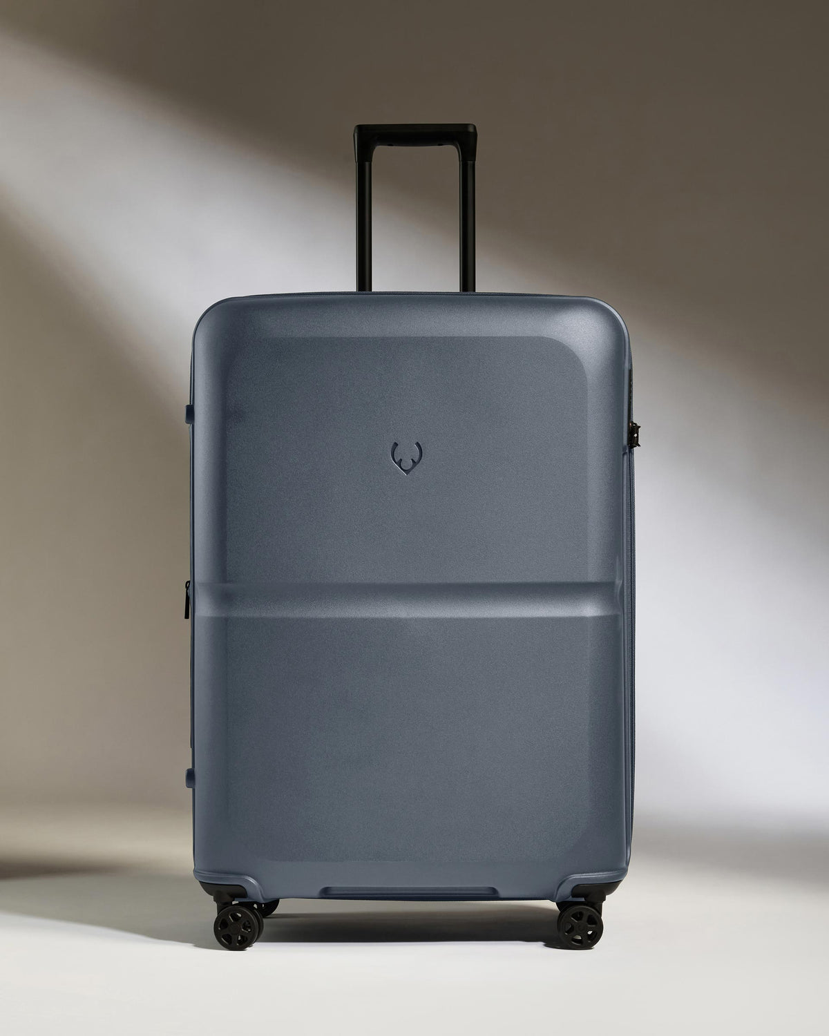 a grey suitcase with wheels