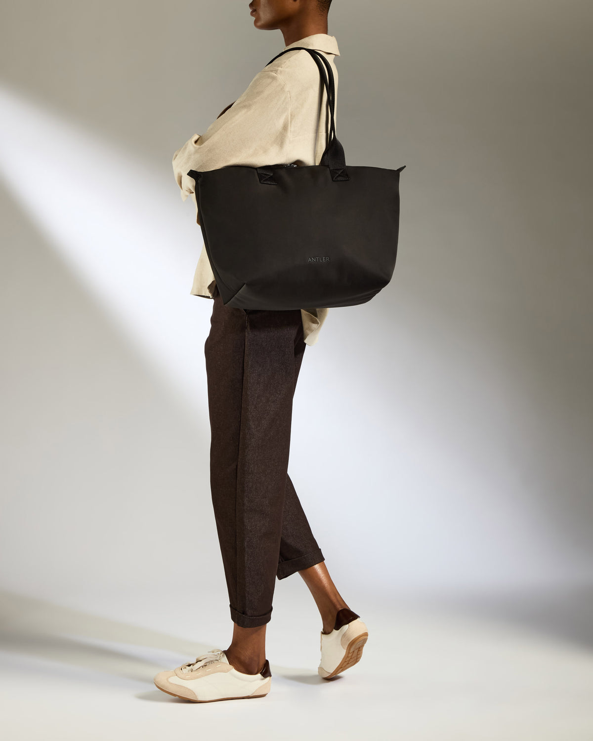 a woman holding a black bag