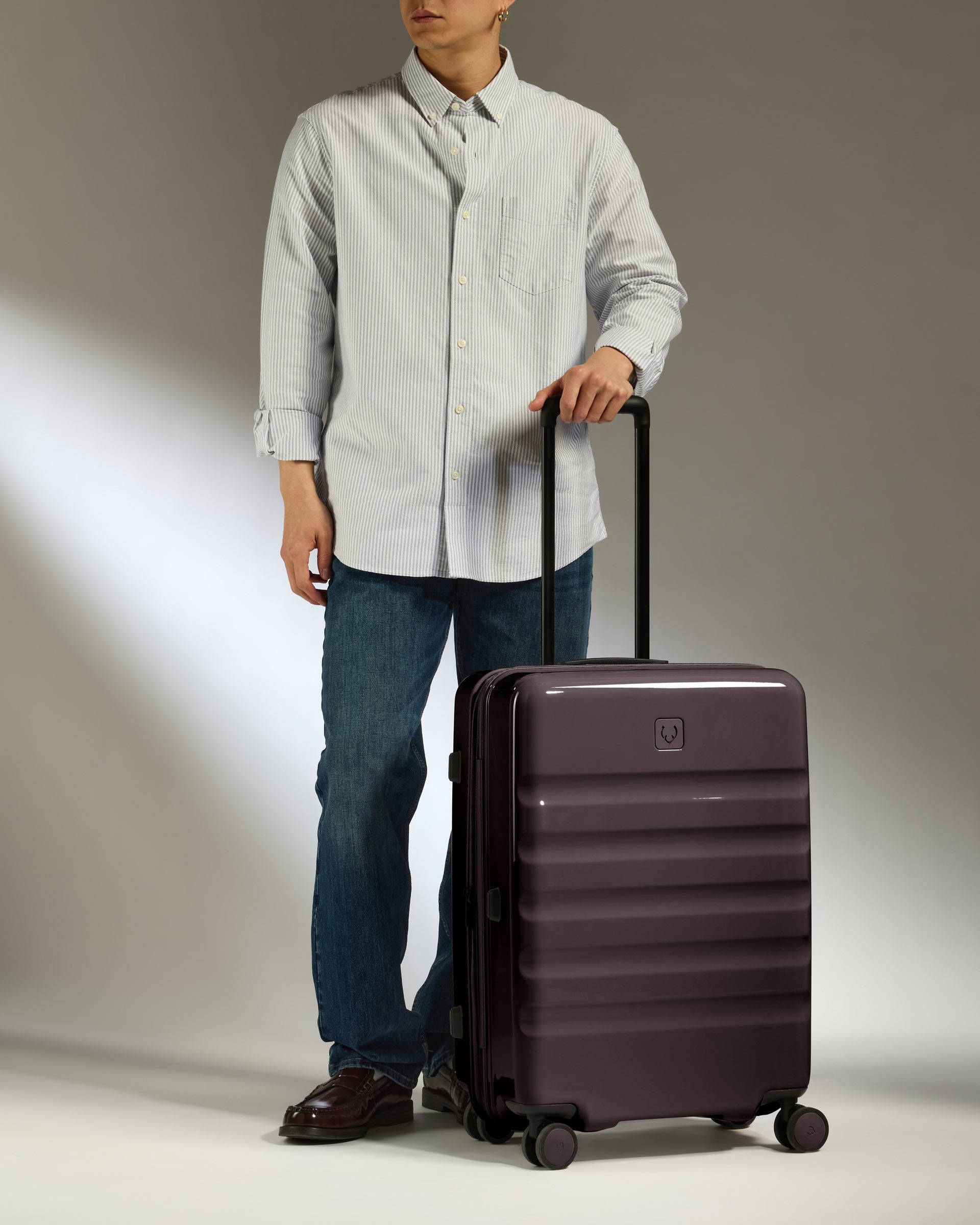 a man standing with a suitcase