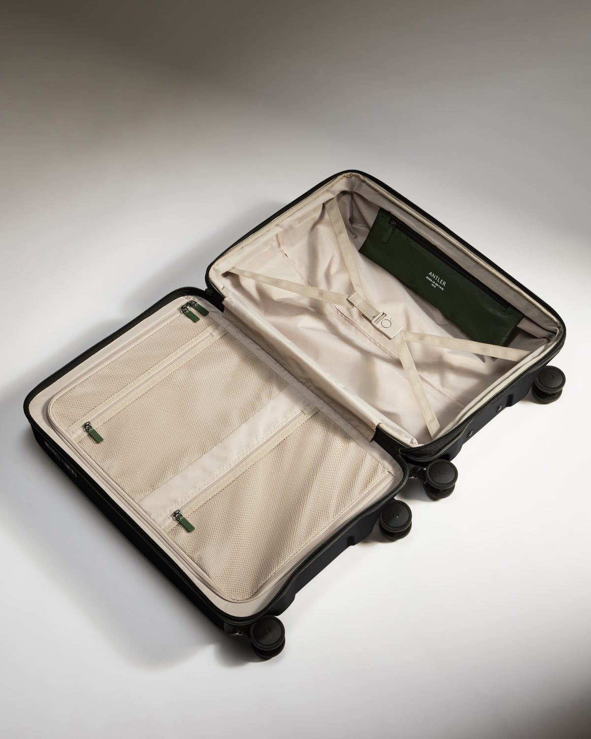 a suitcase with wheels and a green and white cover