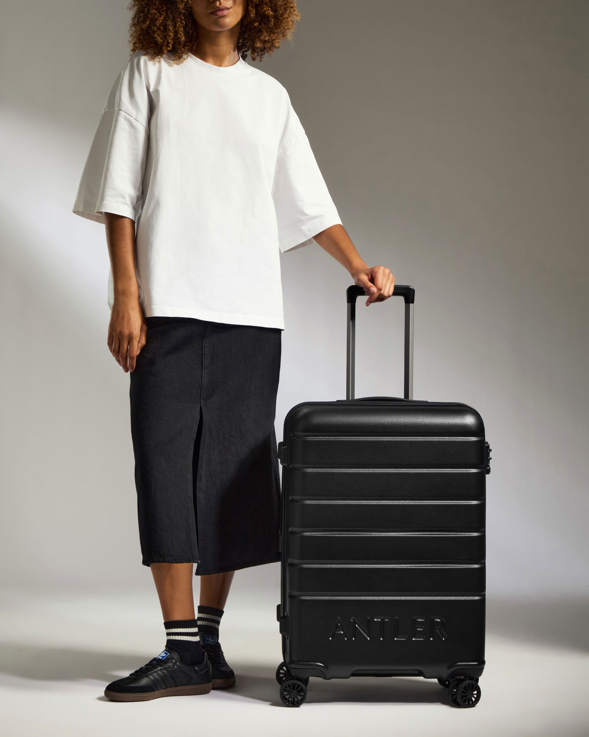 a person standing next to a suitcase
