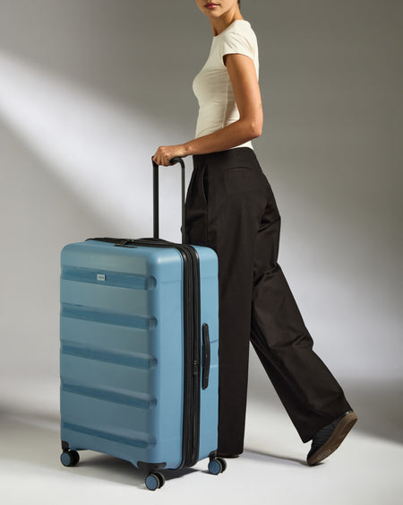 Large Suitcase in Light Blue - Logo Stripe