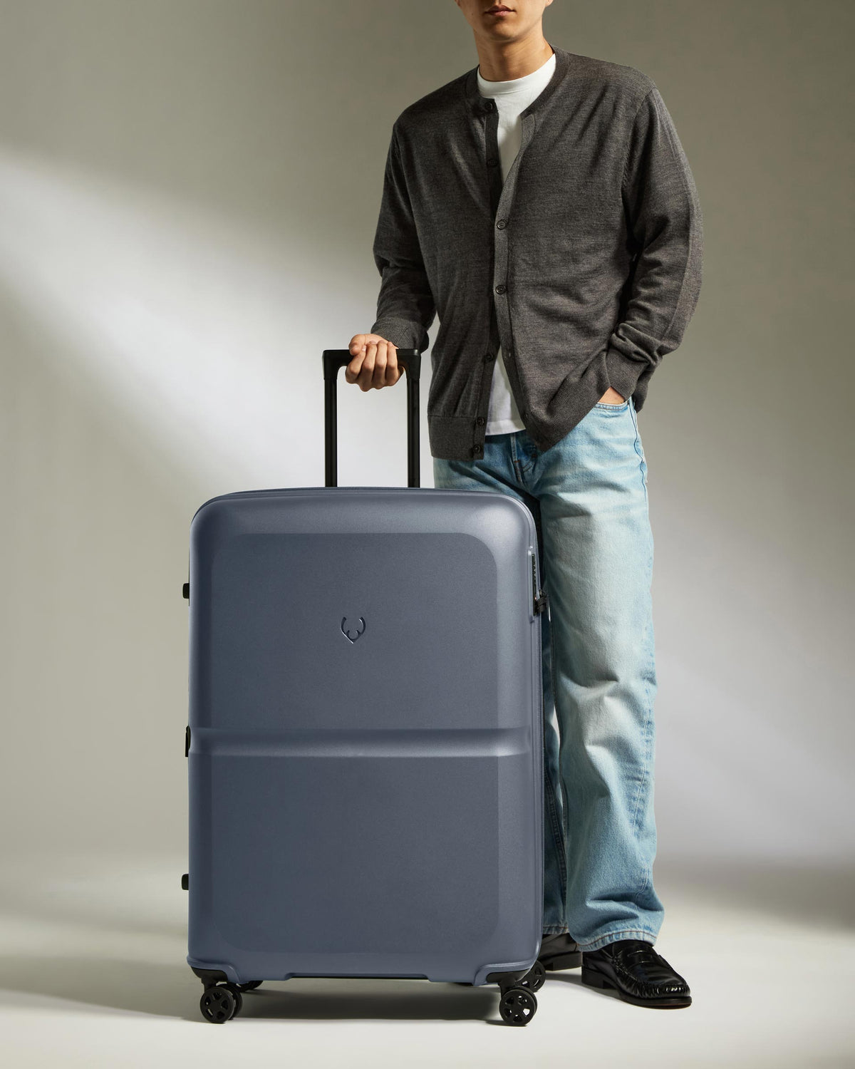 a man standing next to a suitcase