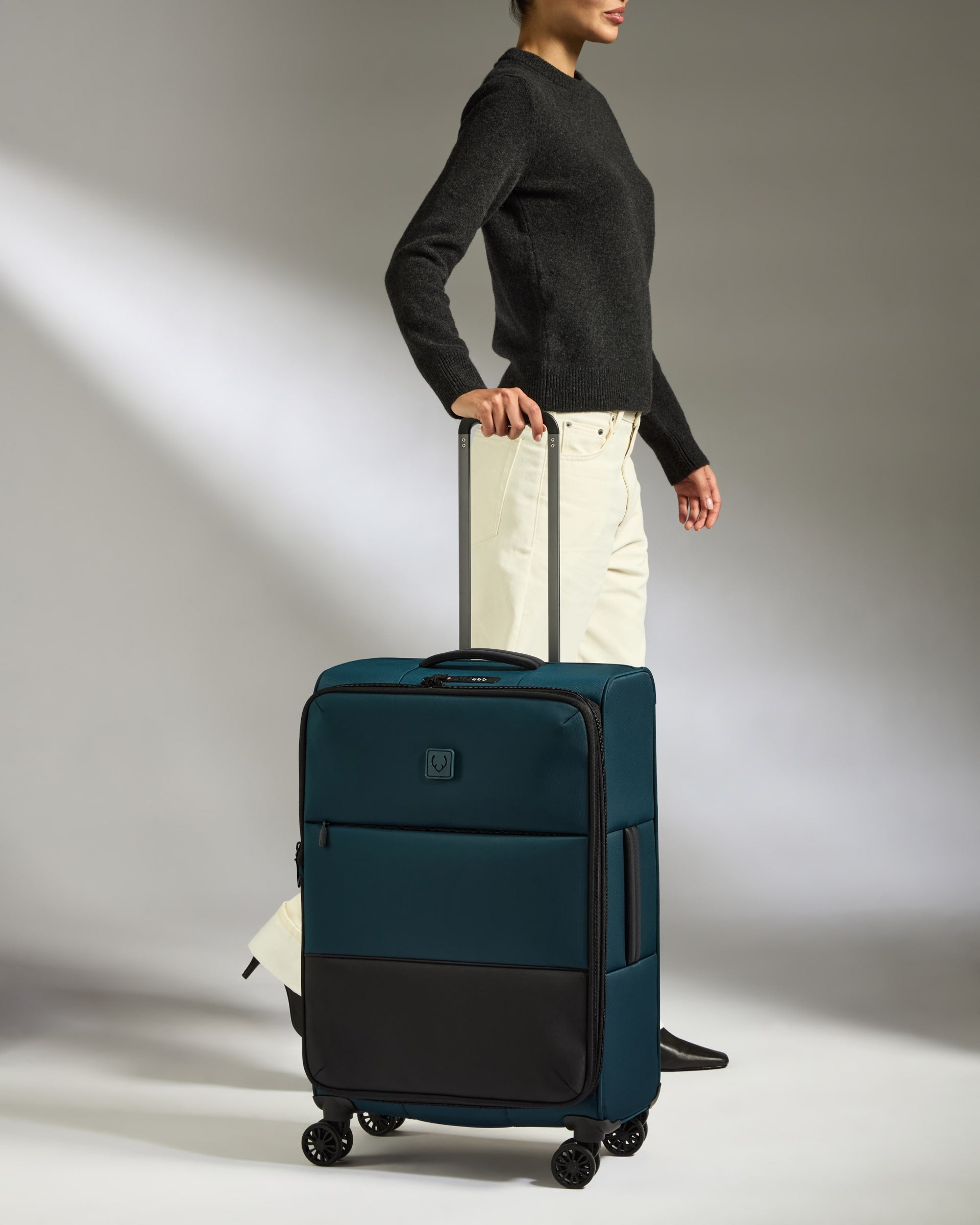 a woman standing with a suitcase