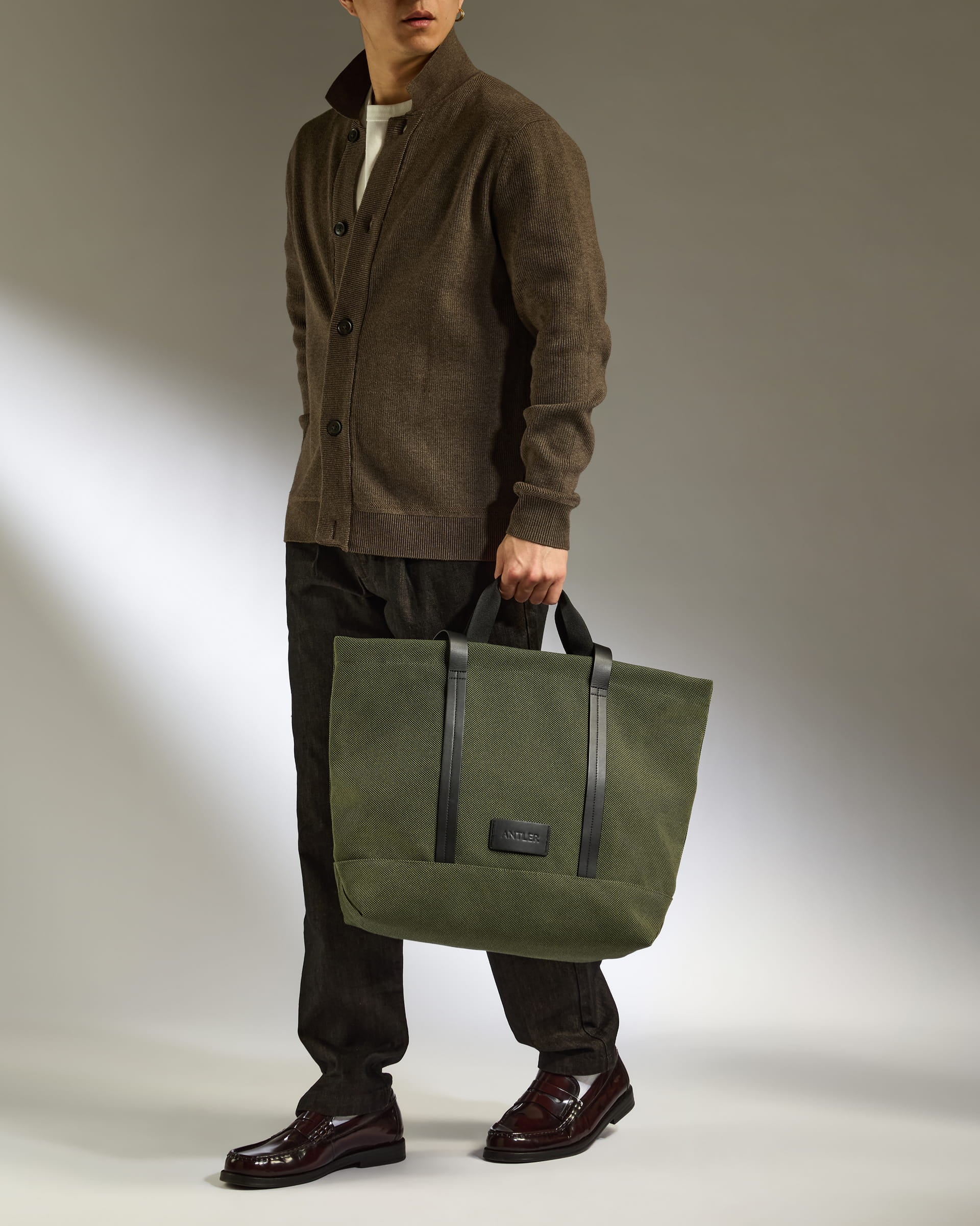 a man holding a green bag