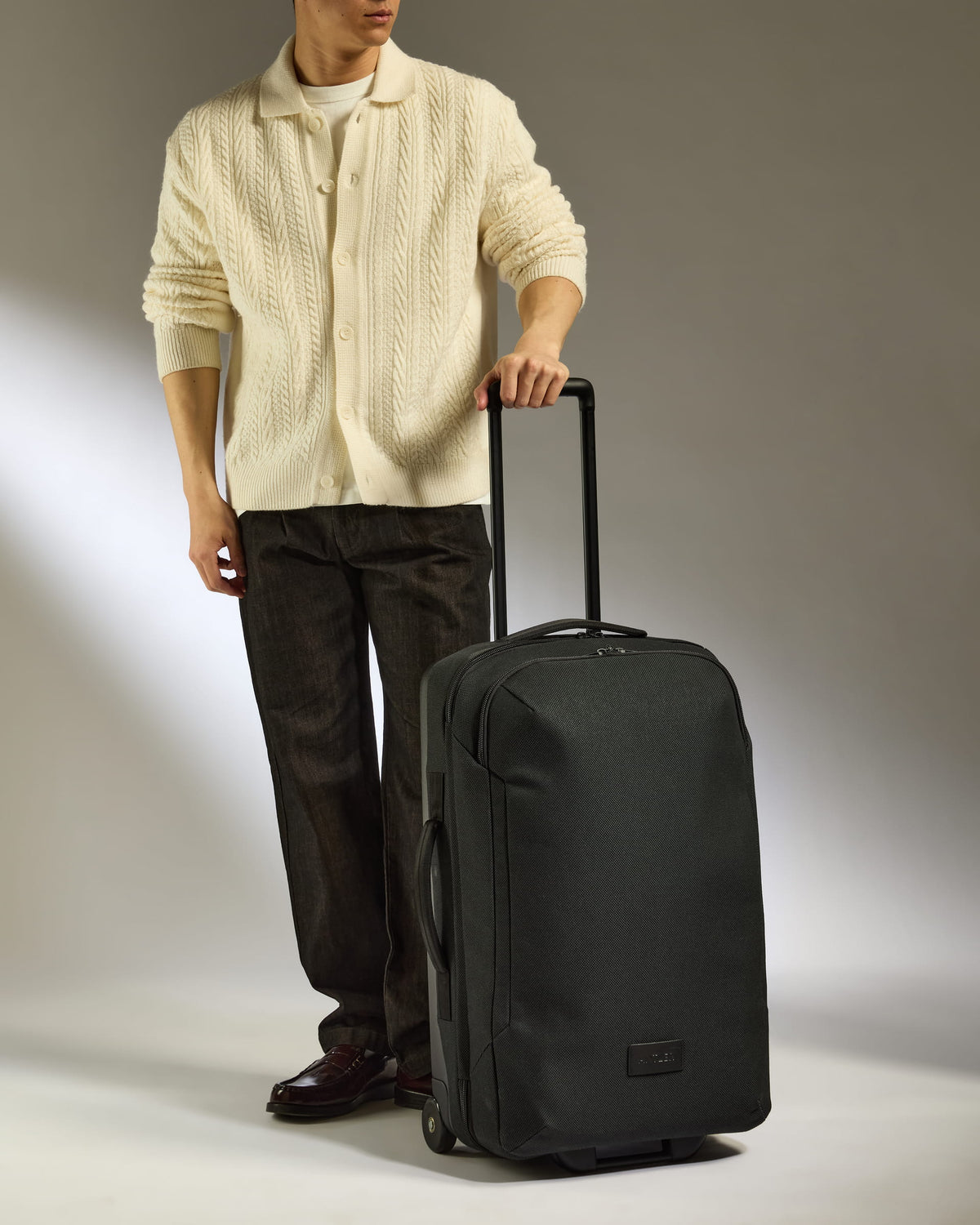 a man standing next to a suitcase