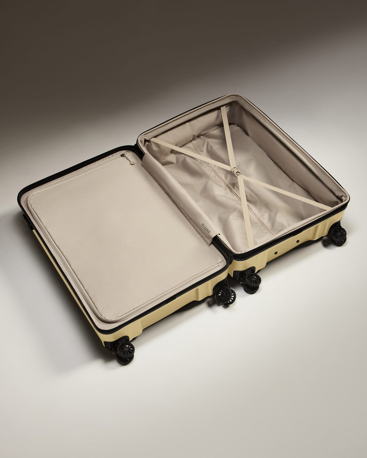Large Suitcase in Dark Sand - Logo