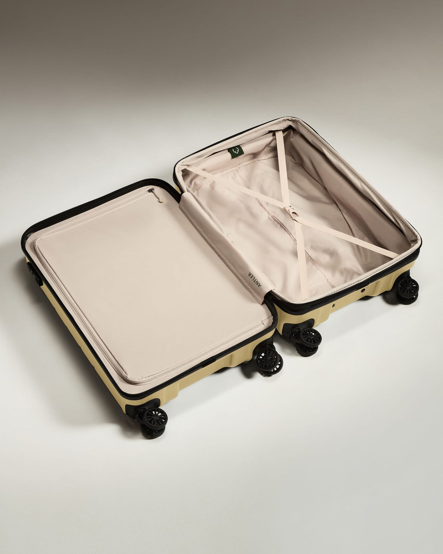 Medium Suitcase in Dark Sand - Logo