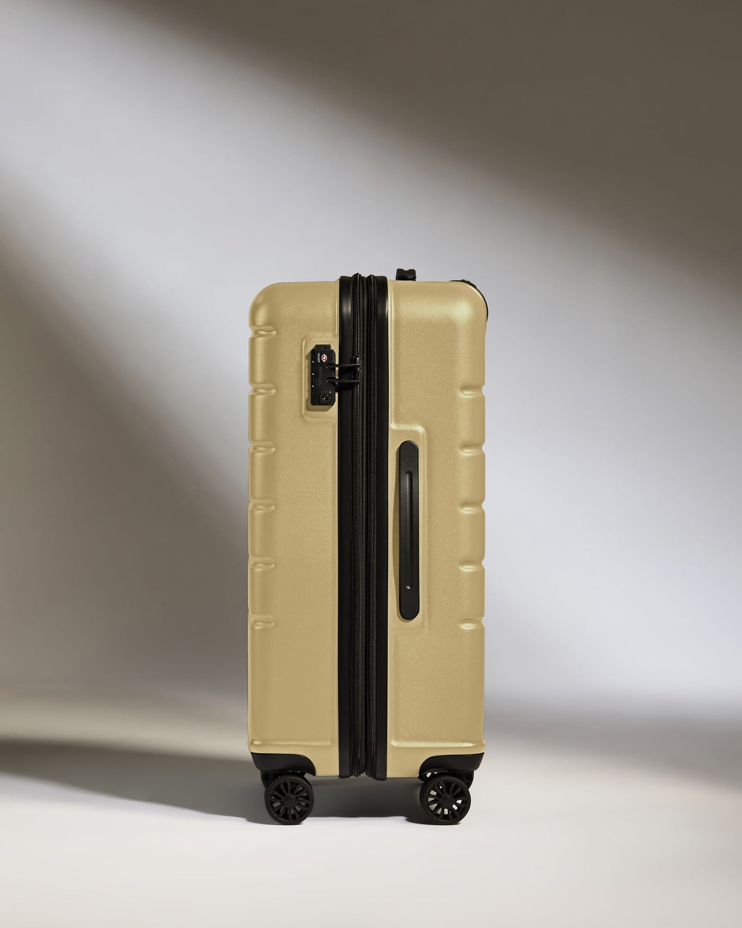 Medium Suitcase in Dark Sand - Logo