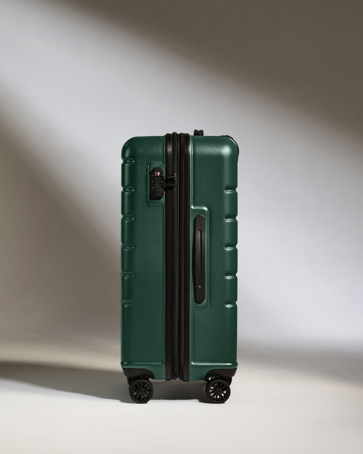 a green suitcase with wheels