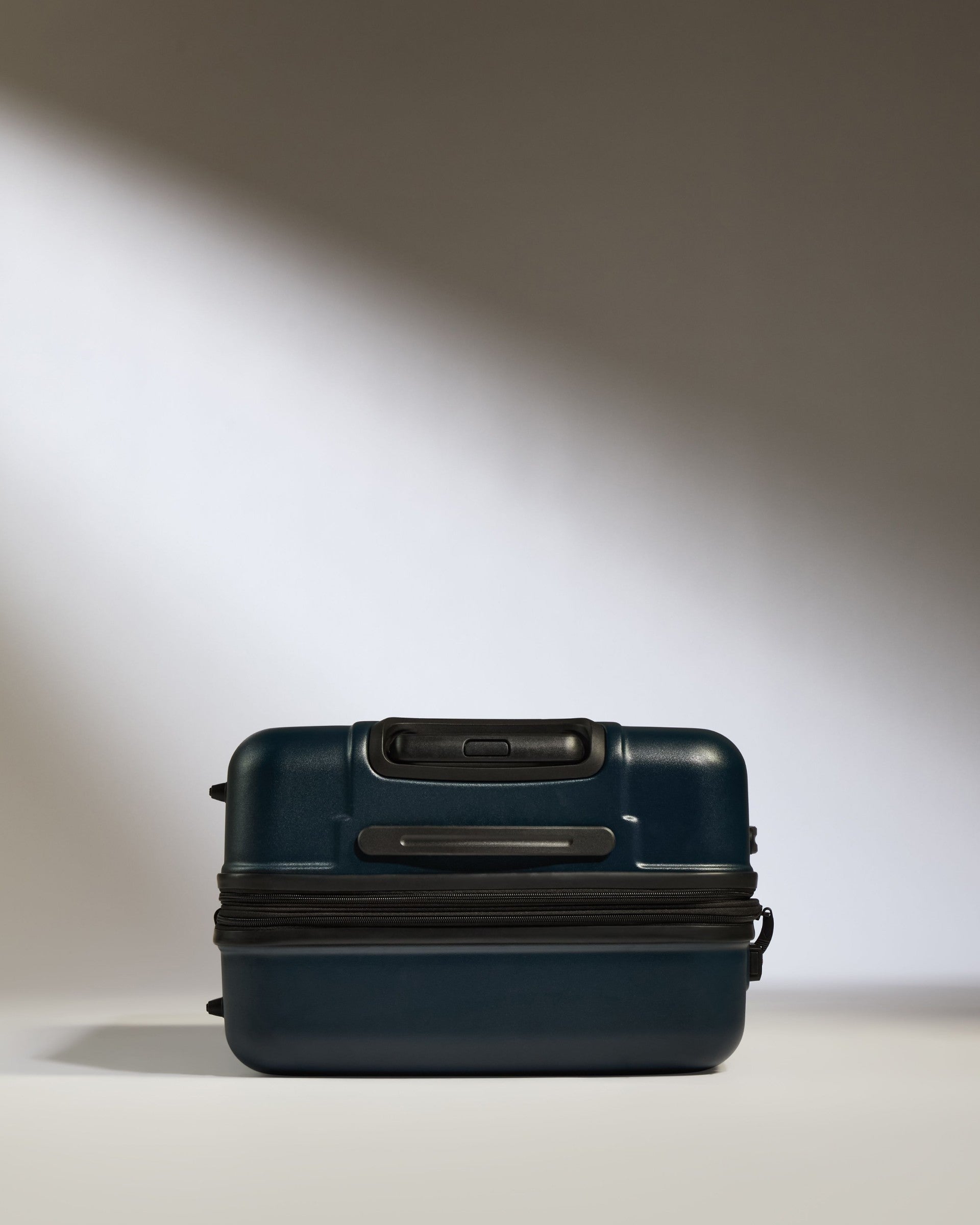 a blue suitcase with a black handle