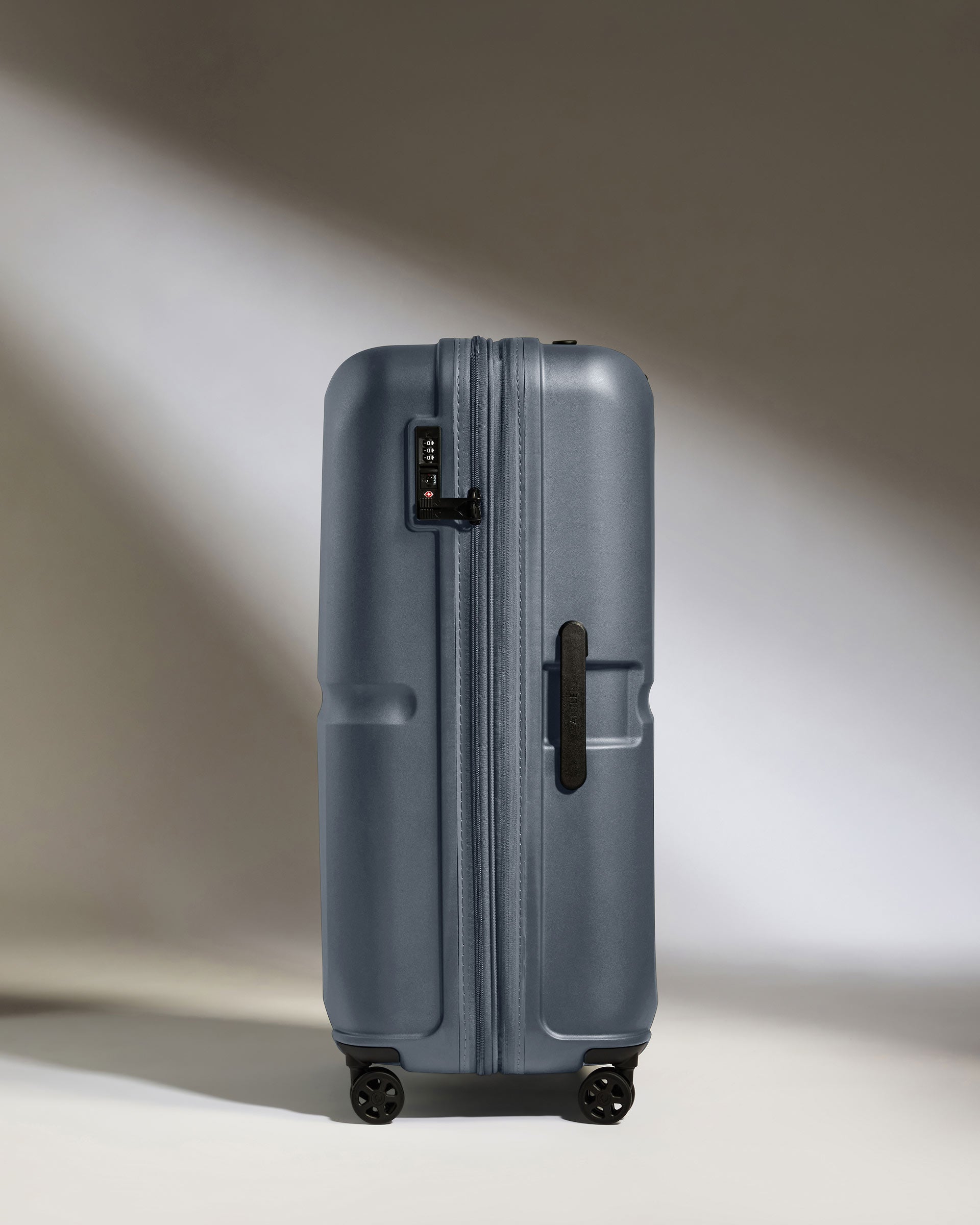 a grey suitcase with wheels