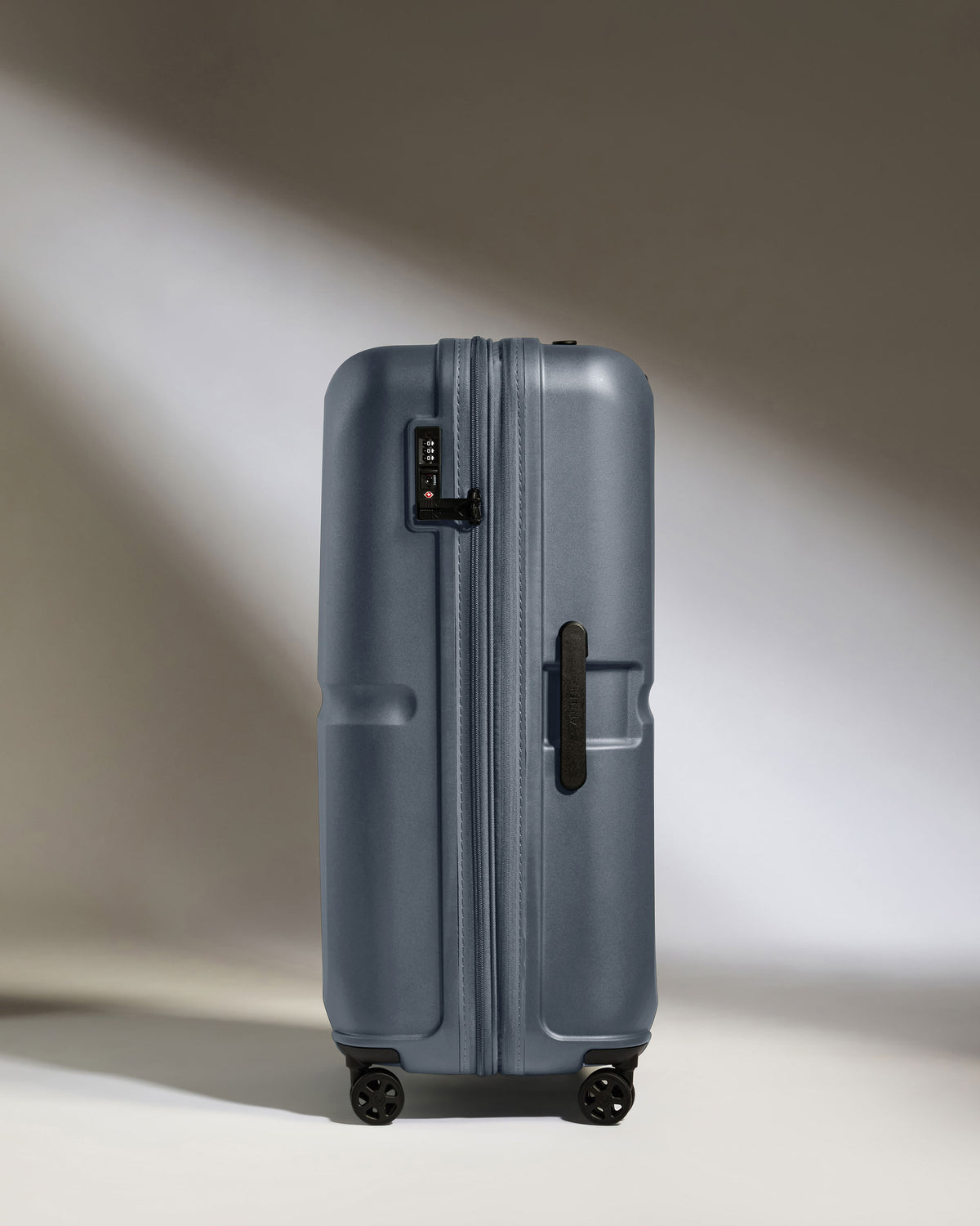 a grey suitcase with wheels