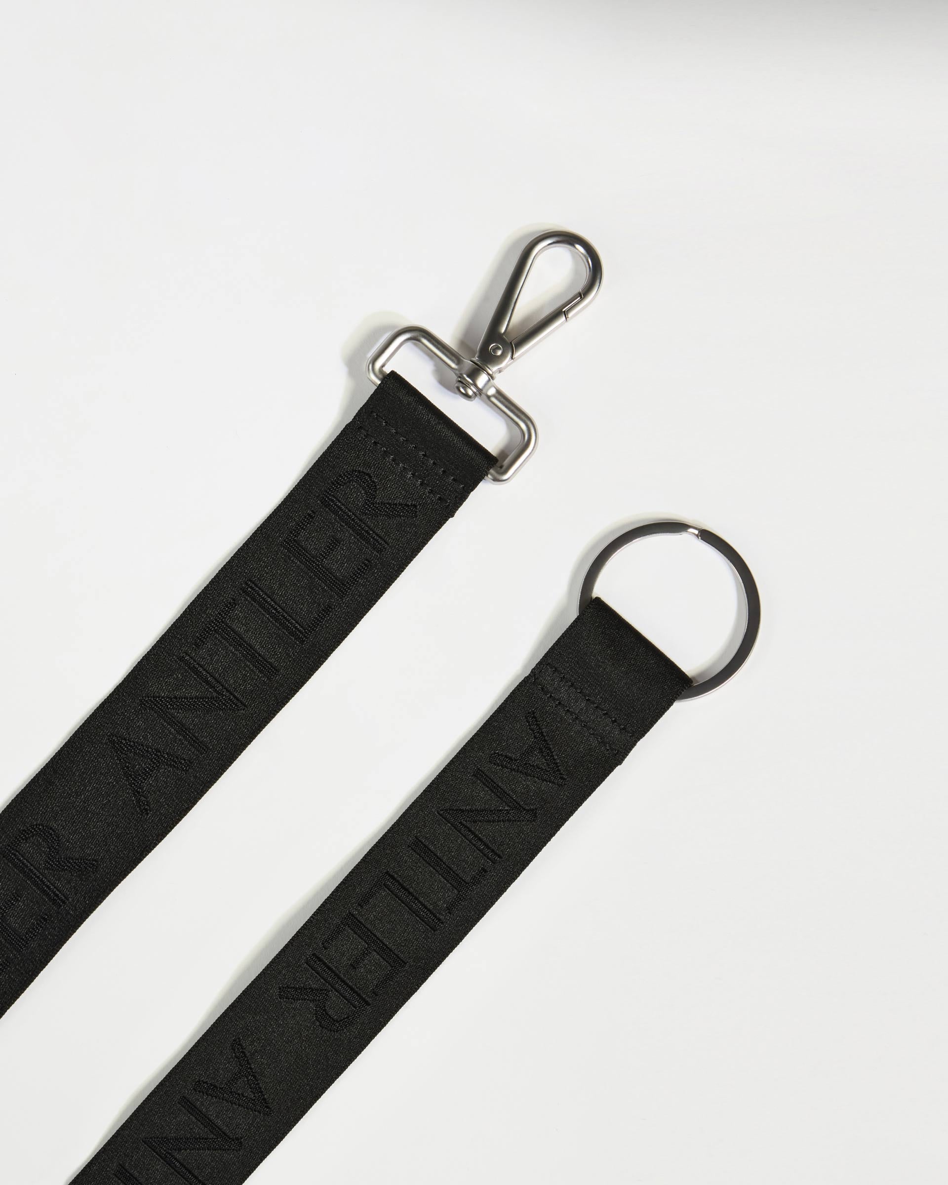 a black strap with a metal clasp