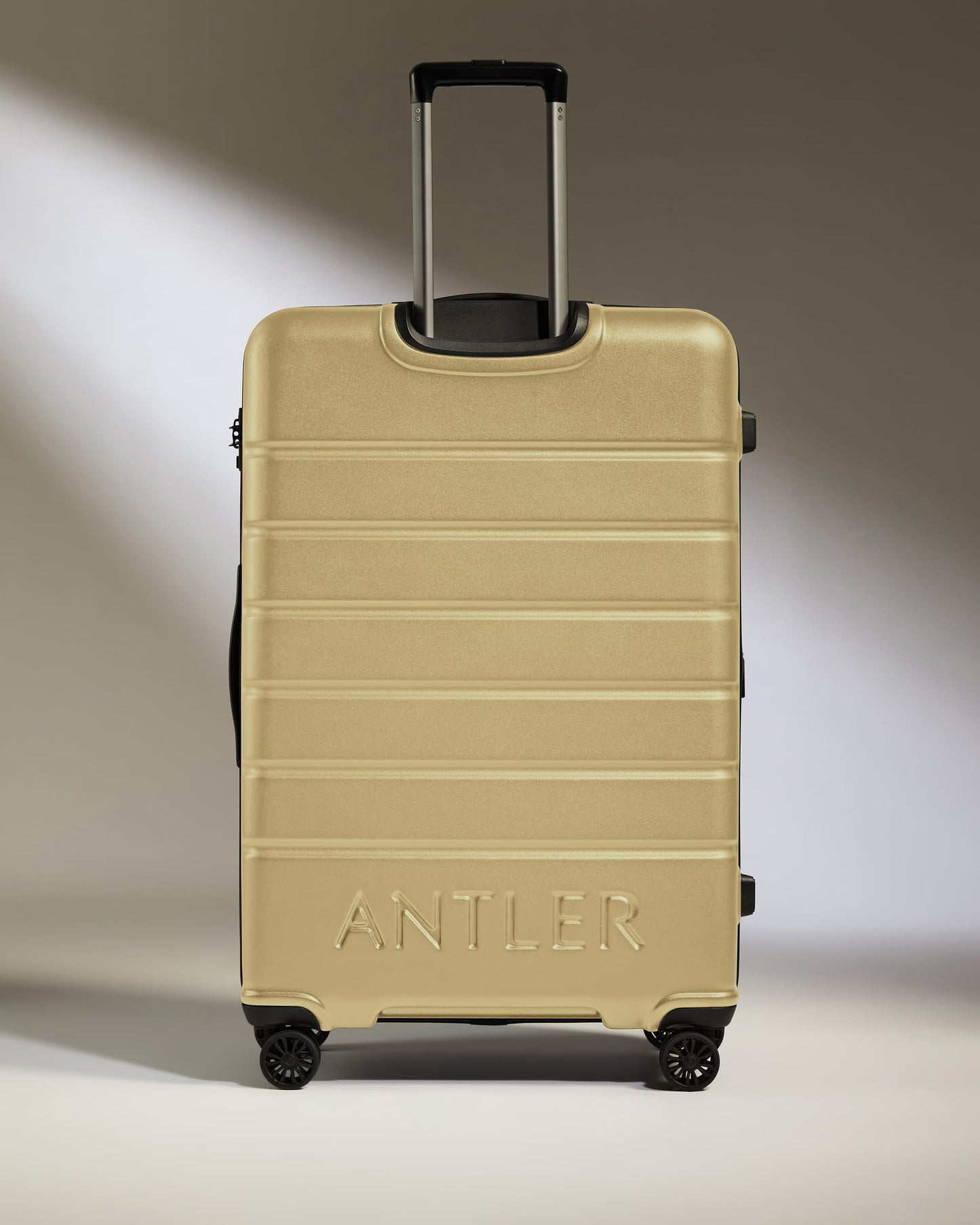 Large Suitcase in Dark Sand - Logo
