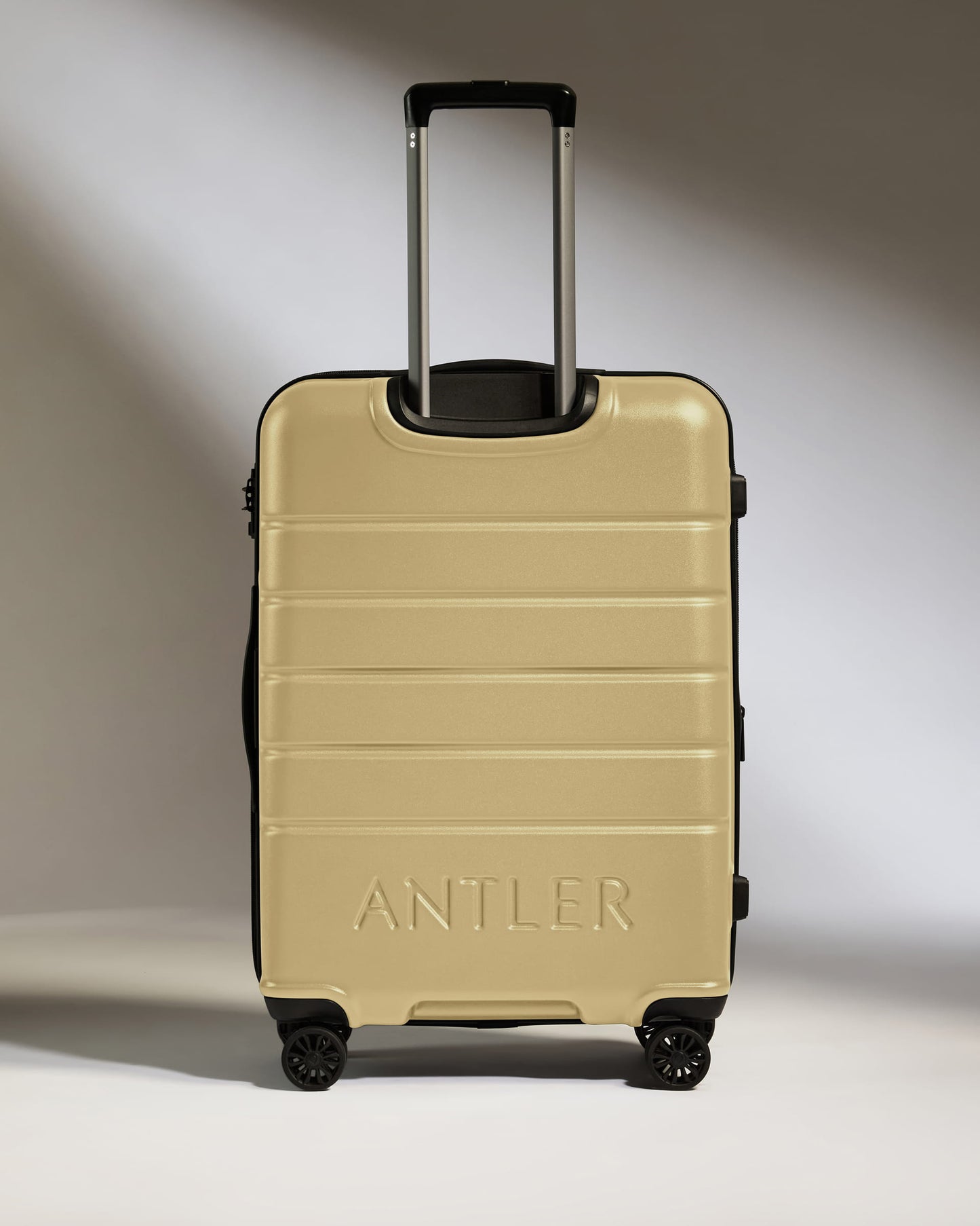 Medium Suitcase in Dark Sand - Logo
