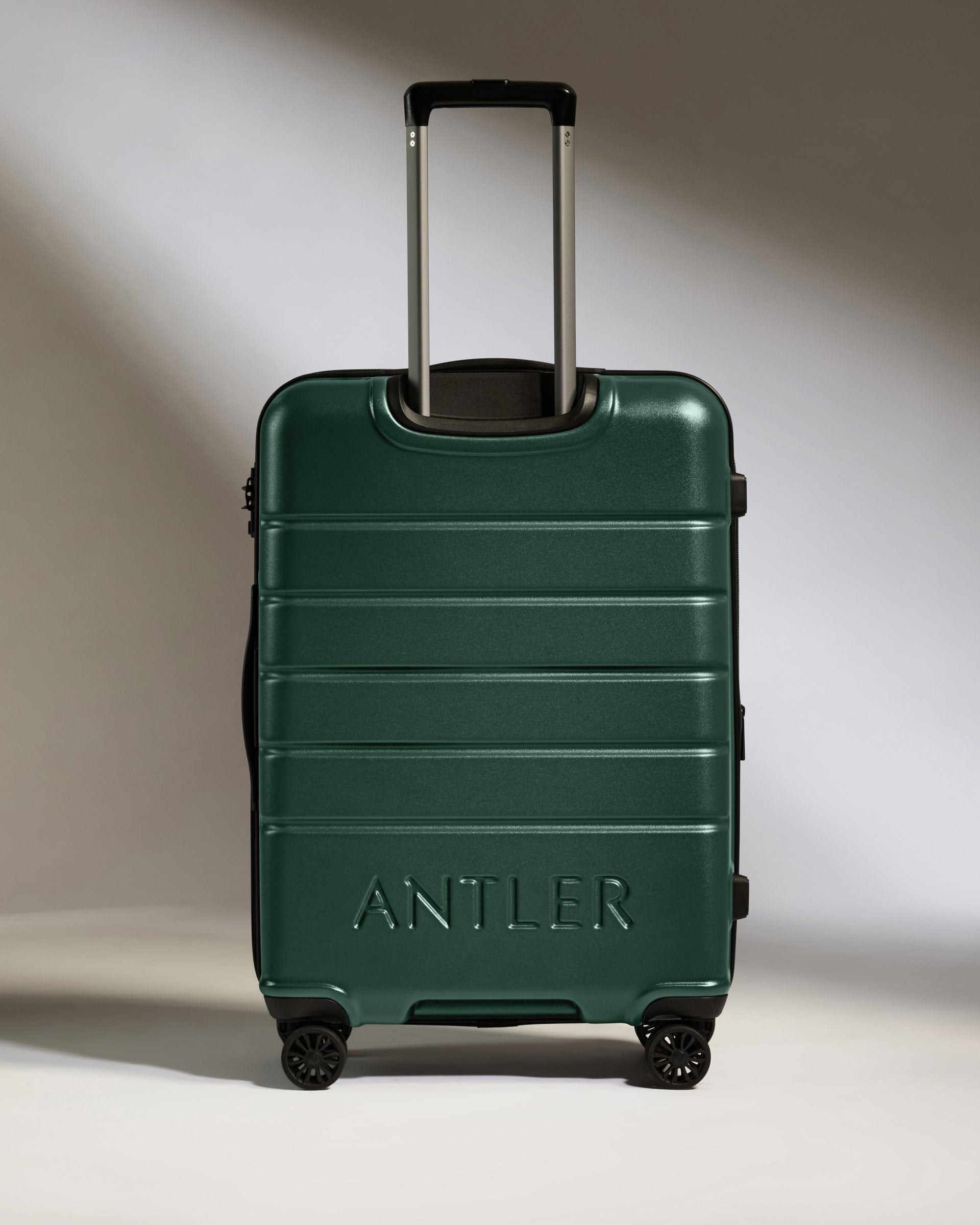 a green suitcase with handle