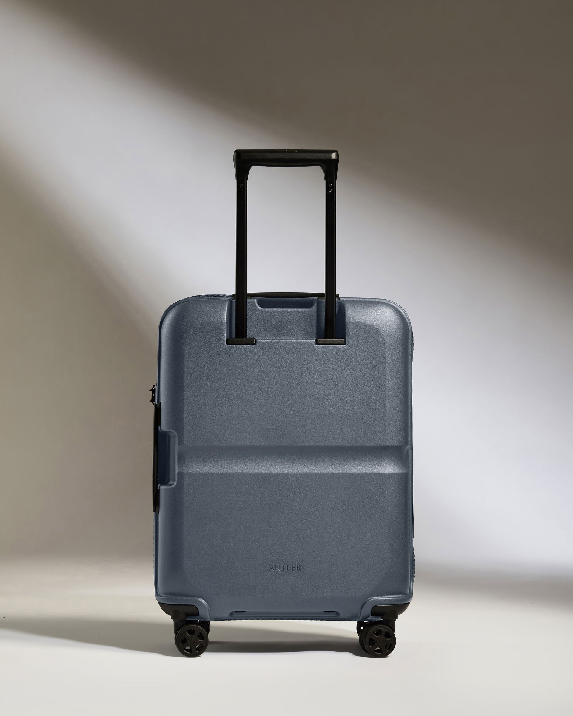 a blue suitcase with black wheels