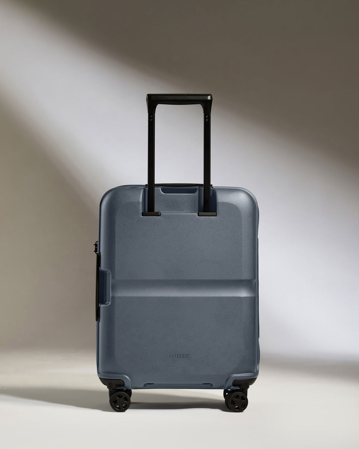 a blue suitcase with black wheels