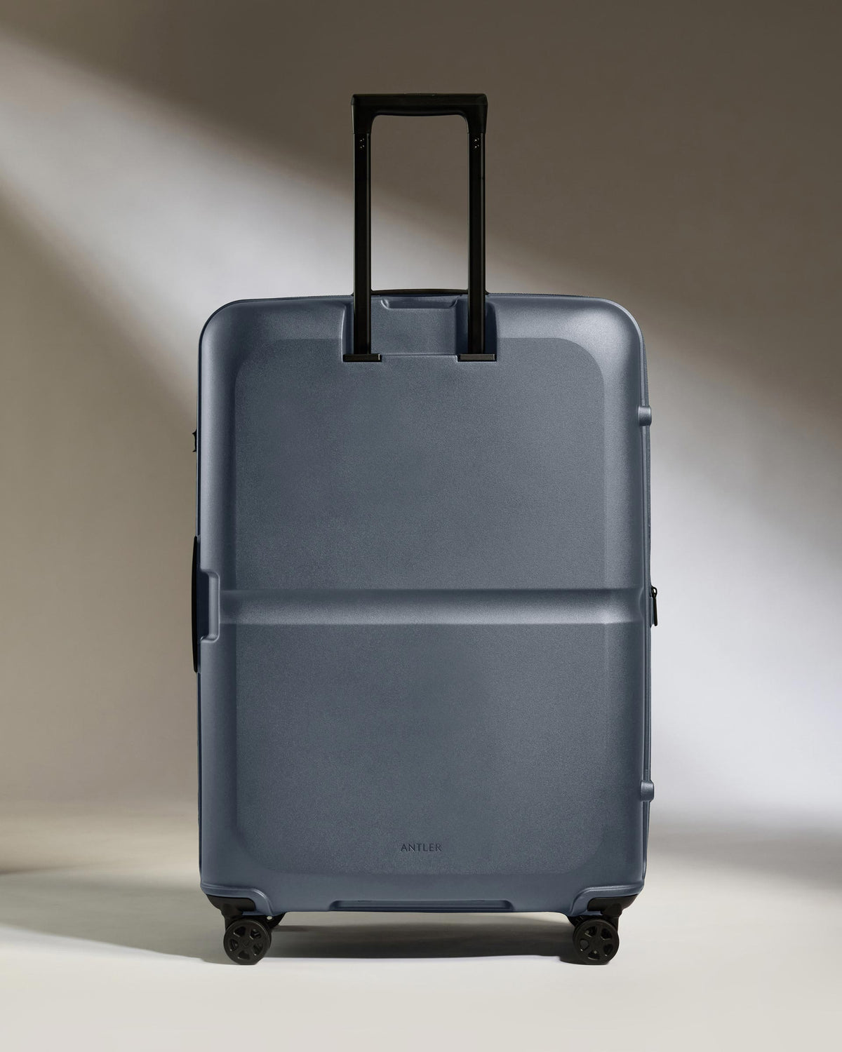 a grey suitcase with black handles