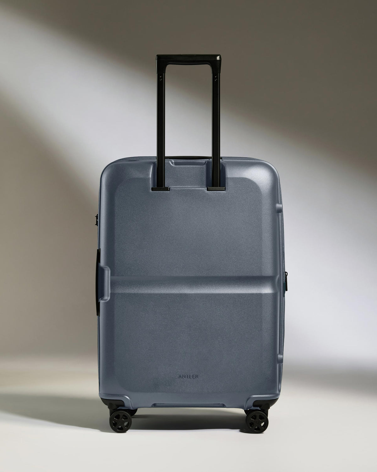 a grey suitcase with black handles
