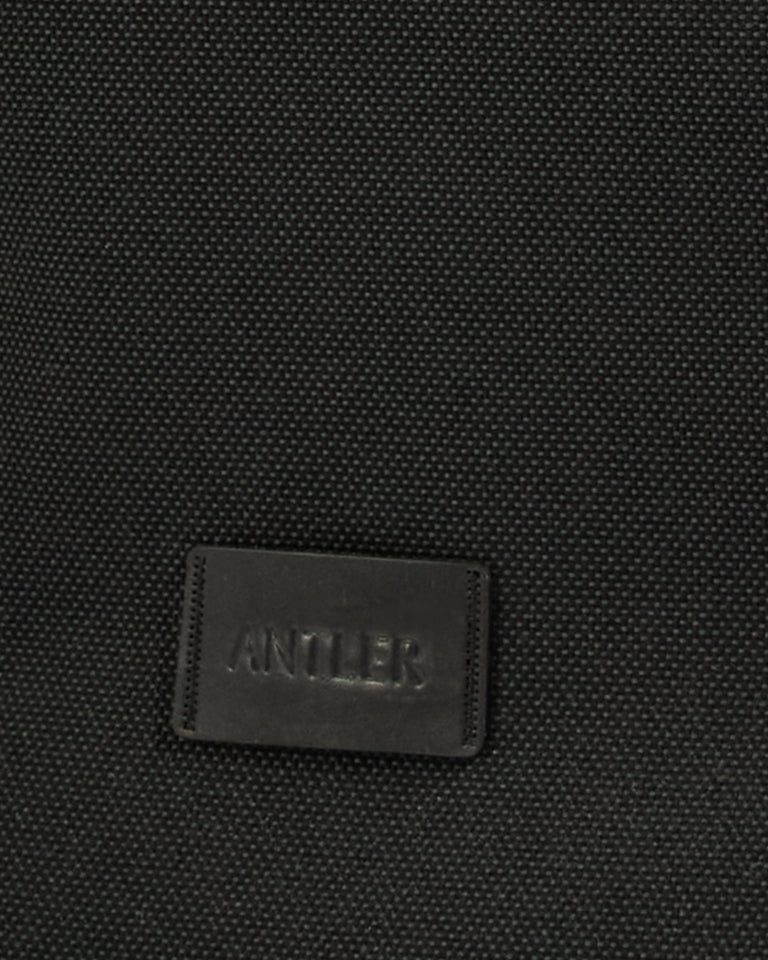 a black leather label on a black surface