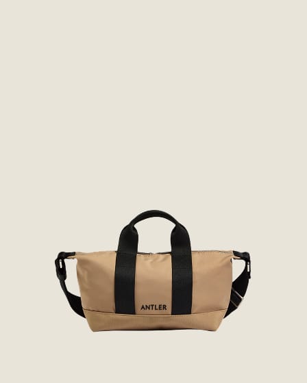 a tan bag with black straps