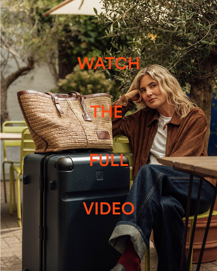 a woman sitting on a suitcase